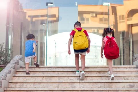 Back to school. Pupils with backpacks going to school Stock Photos