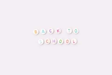 Back to school. Quote made of white round beads with multicolored letters. Stock Photos