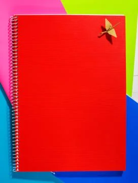 Back to school. The red notebook is on colored paper Stock Photos
