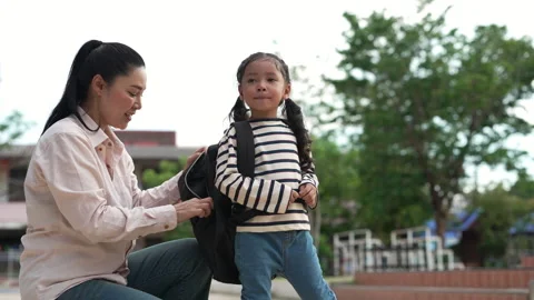 Back to school. Smiling young mother and preschool student girl with backpack an Stock Footage 338150648
