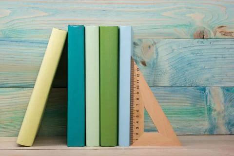 Back to school. Stack of colorful books on wooden table. Copy space Stock Photos