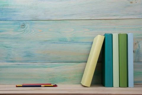 Back to school. Stack of colorful books on wooden table. Copy space Stock Photos