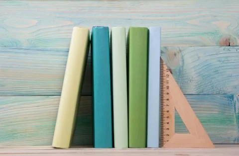 Back to school. Stack of colorful books on wooden table. Copy space Stock Photos