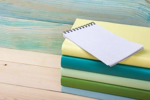 Back to school. Stack of colorful books on wooden table. Copy space Stock Photos