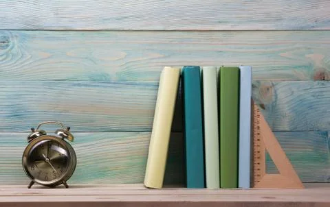 Back to school. Stack of colorful books on wooden table. Copy space Stock Photos