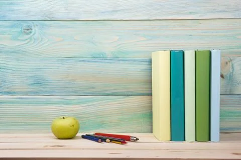 Back to school. Stack of colorful books on wooden table. Copy space Stock Photos