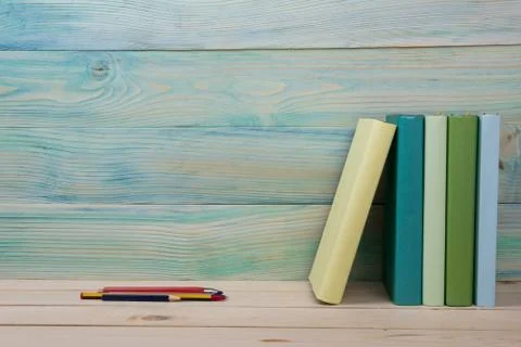 Back to school. Stack of colorful books on wooden table. Copy space Stock Photos