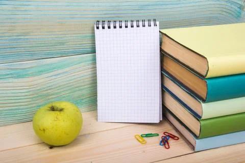 Back to school. Stack of colorful books on wooden table. Copy space Stock Photos