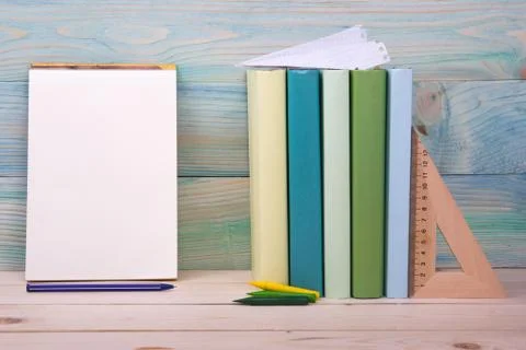 Back to school. Stack of colorful books on wooden table. Copy space Stock Photos