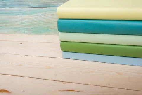 Back to school. Stack of colorful books on wooden table. Copy space Stock Photos