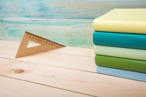Back to school. Stack of colorful books on wooden table. Copy space Stock Photos