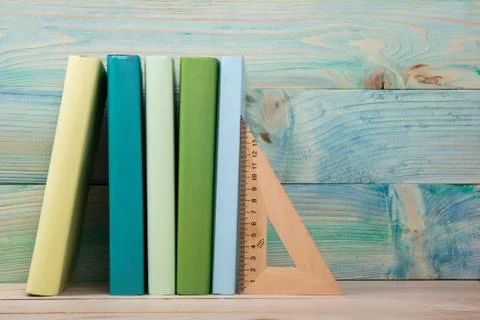 Back to school. Stack of colorful books on wooden table. Copy space Stock Photos