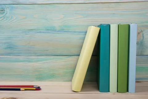 Back to school. Stack of colorful books on wooden table. Copy space Stock Photos