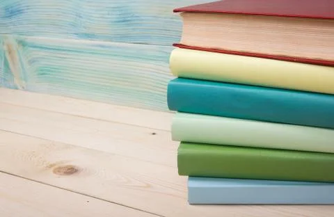 Back to school. Stack of colorful books on wooden table. Copy space Stock Photos