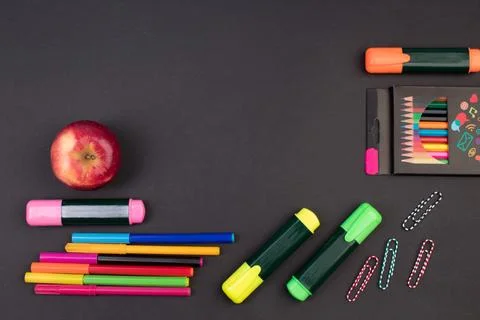 Back to school. Stationery on a black table. Office desk with copy space. Fla Stock Photos