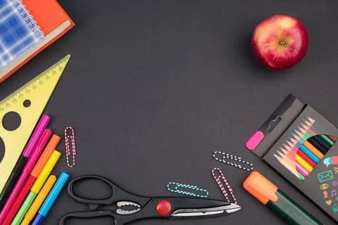 Back to school. Stationery on a black table. Office desk with copy space. F.. Stock Photos