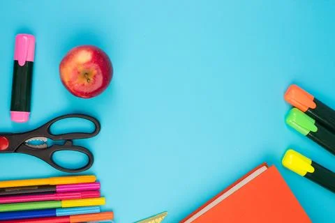 Back to school. Stationery on a blue table. Office desk with copy space. Fl.. Stock Photos