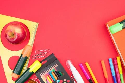 Back to school. Stationery on a red table. Office desk with copy space. Fla.. Stock Photos