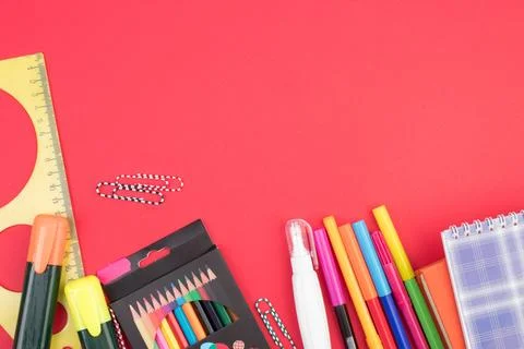 Back to school. Stationery on a red table. Office desk with copy space. Fla.. Stock Photos