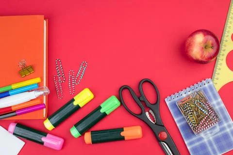 Back to school. Stationery on a red table. Office desk with copy space. Fla.. Stock Photos