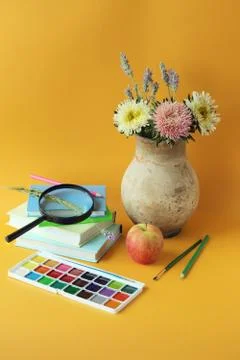 Back to school, stationery, stack of books, vase of flowers, paints Stock Photos