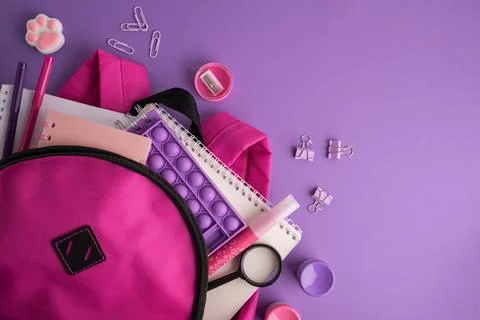 Back to school supplies, backpack, notebooks, pens, pop it toy Stock Photos