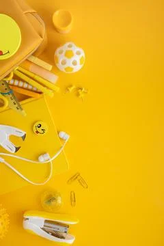 Back to school supplies flat lay on yellow background Stock Photos