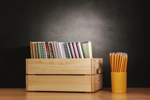 Back to school, On table there is wooden box filled with notebooks and glass  Stock Photos