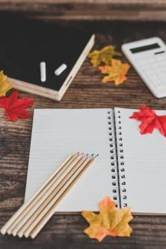 Back to school tabletop arrangement with coloured pencils notepad and mixed s Stock Photos