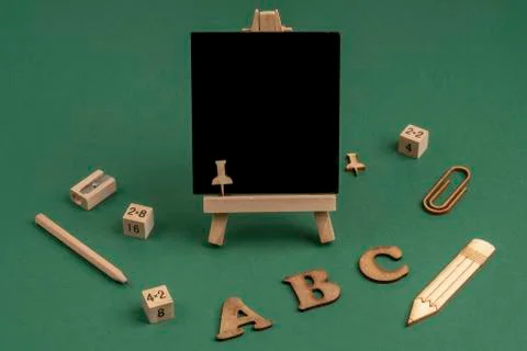 Back to school template with a blank chalkboard on green background Stock Photos