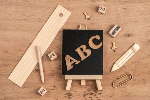 Back to school template with a chalk board and pencils on table Stock Photos