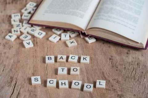 Back to school template with cube letters and book on table Stock Photos