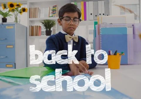 Back to school text against office kid boy holding folders background Foto stock