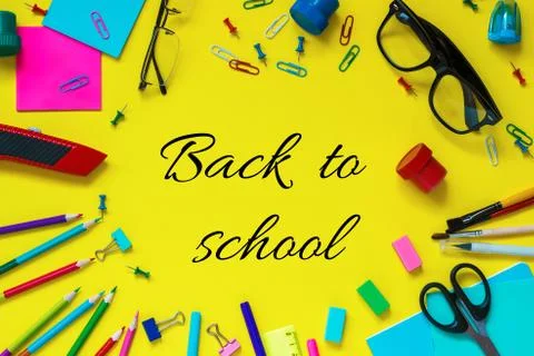 Back to school text and school pupil stationery glasses on yellow paper backg Stock Photos
