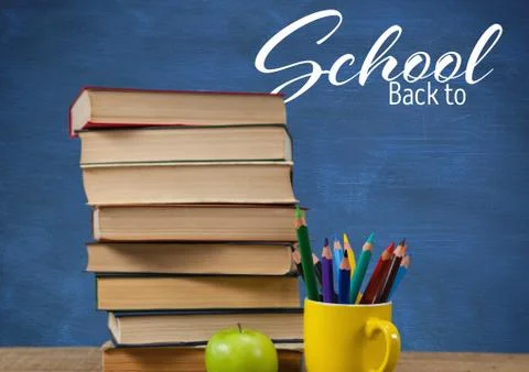 Back to School text on blackboard and Books on Desk foreground 写真素材