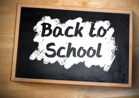 Back to school text on blackboard Stock Photos
