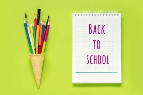 Back to school text on white notepad and colored pencils in waffle ice cream  Stock Photos