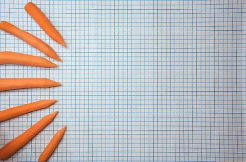 Back to school theme carrot snacks as stationery items on checkered background Stock Photos