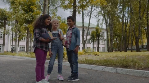 Back to school. Three Friends With Backpacks huging and laughing in front of Video stock 112669370