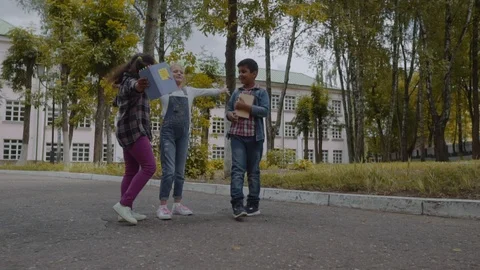 Back to school. Three Friends With Backpacks huging and laughing in front of Video stock 112669397