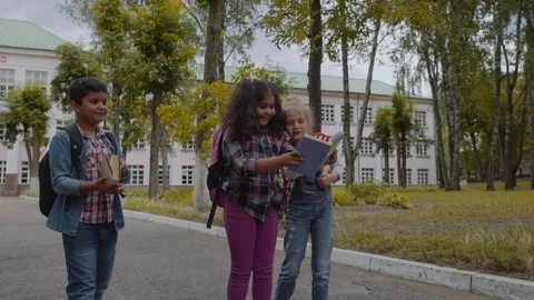 Back to school. Three Friends With Backpacks huging and laughing in front of Video stock 112669482