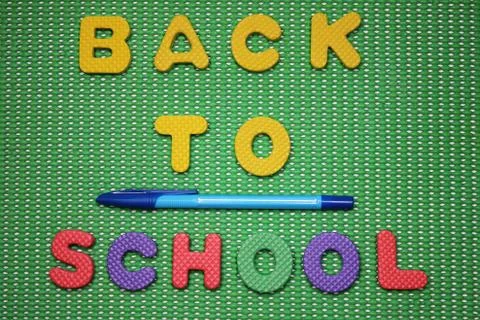Back to school words are lined with colored letters on a green background nex Stock Photos