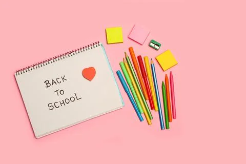 Back to school write in a notebook, colored pencils and markers Stock Photos
