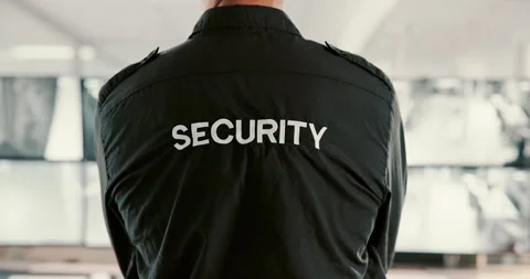 Back, security guard and man in office, video surveillance and computer with Stock Footage 303708867