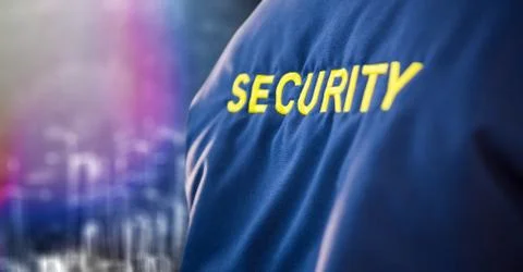 Back of security guard jacket against blurry wall with city sketch Stock Photos