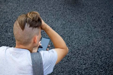 Back of shaved head with pony tail of young man Stock Photos