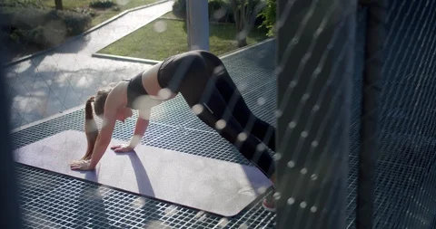Back shoot of strong woman practicing yoga outdoor content of healthy lifestyle Stock Footage 117543462