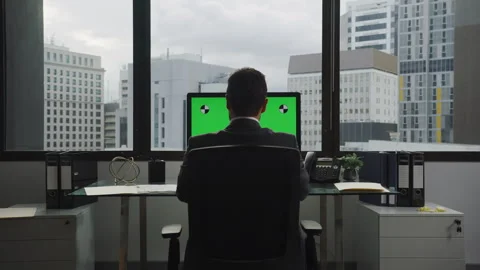 Back shot of Businessman using a computer with green screen Stock Footage 264243382