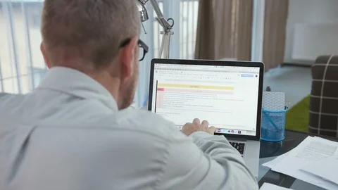 Back shot of good-looking Slavic grandfather at silver laptop. Portrait of Stock Footage 95768395