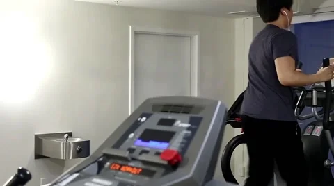 Back shot of man running on a treadmill Stock Footage 51021128
